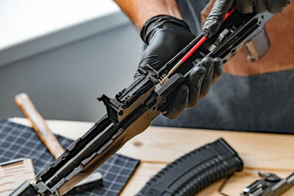 A gunsmith repairing a rifle closeup