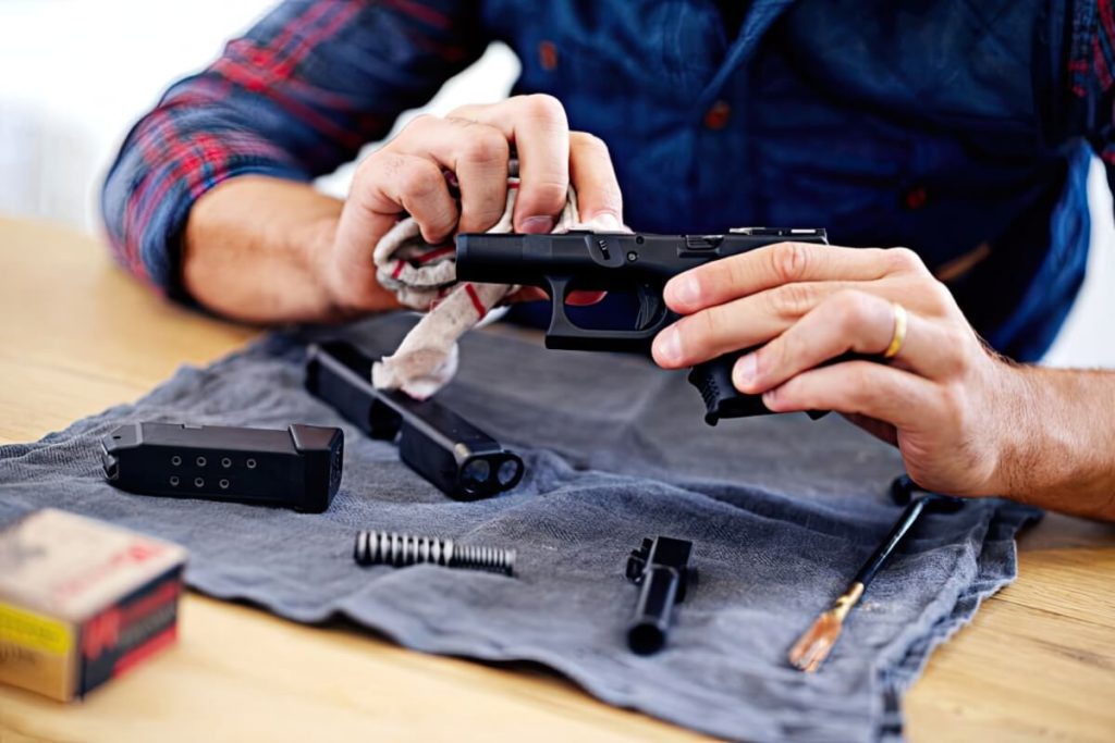 A man cleaning his handgun