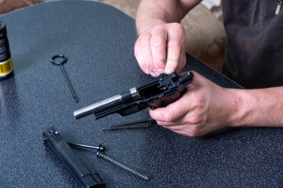 A closeup of a pistol being cleaned